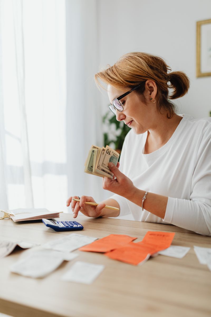 A family planning their weekly grocery budget together at a kitchen table with a shared shopping list.